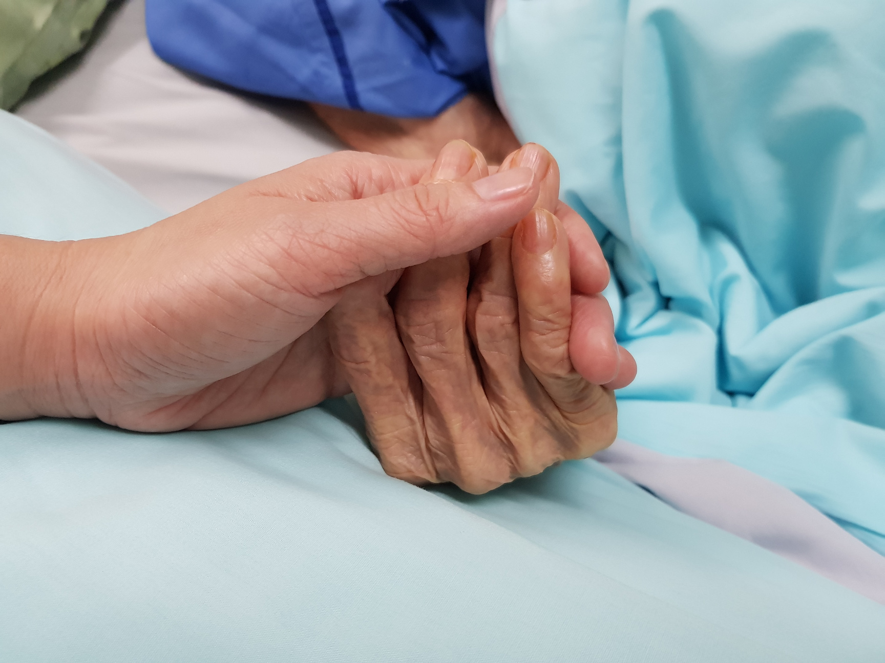 Holding grandmother's hand in the nursing care. Showing all love, empathy, helping and encouragement : healthcare in end of life and palliative concept